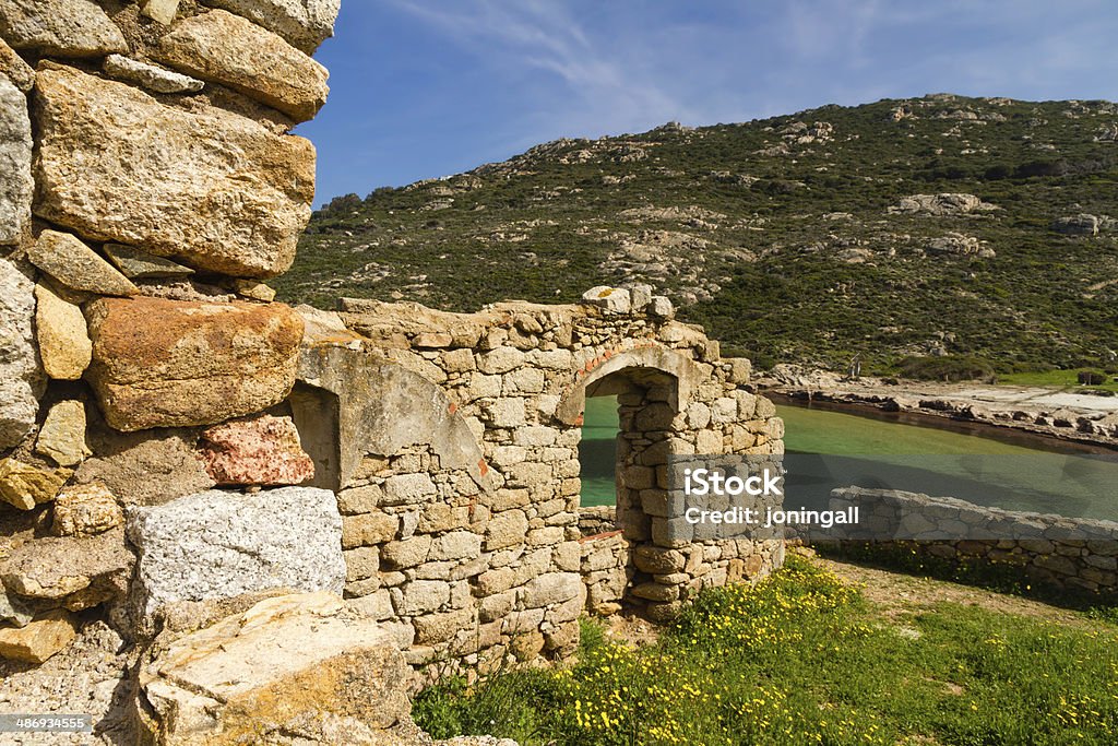 Ancient ruined building on the coast of Corsica An ancient ruined building overlooking the turquoise mediterranean on the coast of La Revellata near Calvi in Corsica Abandoned Stock Photo