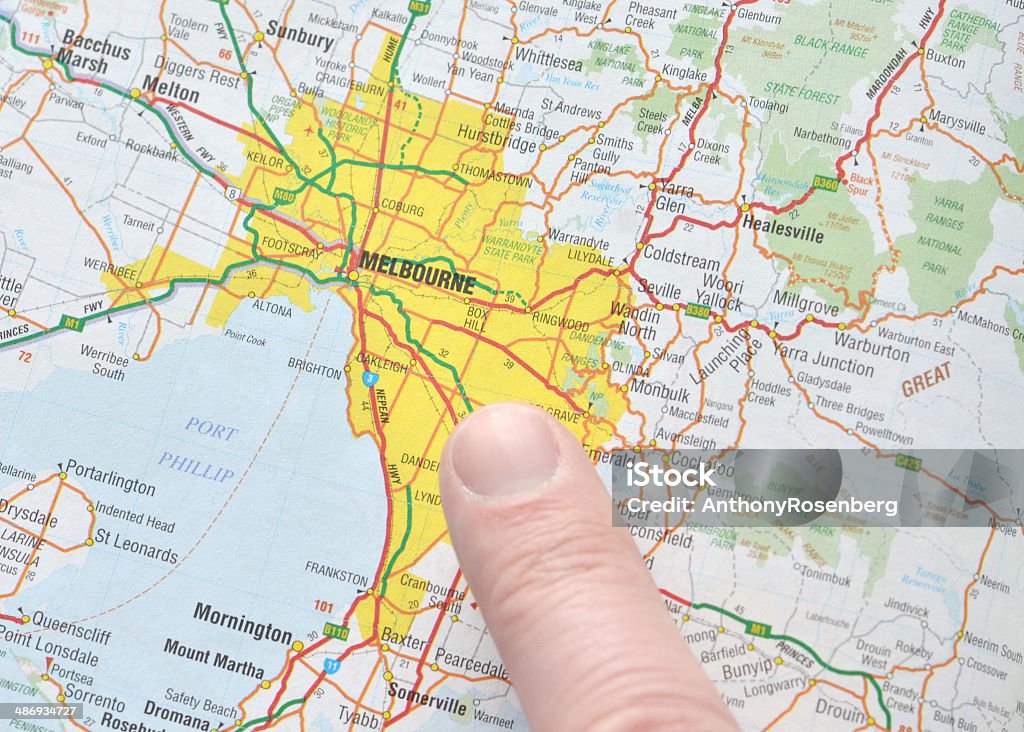 Pointing to Melbourne on the Map Close up of man's finger pointing to Melbourne, Australia on a generic, mass produced map.   Map Stock Photo