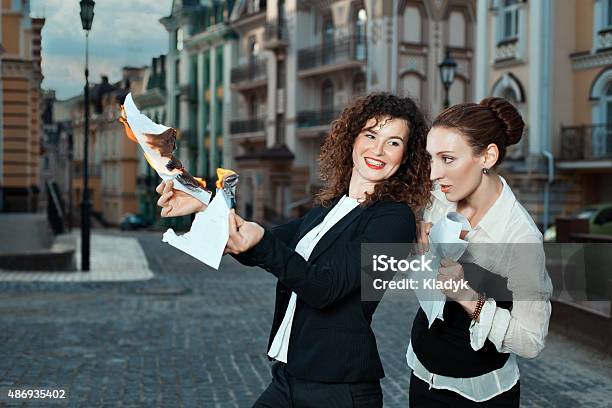Girl Burns The Papers A Watching Other Girl Stock Photo - Download Image Now - 2015, Activity, Adult