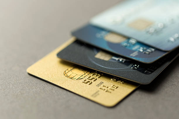 Credit cards Close up of credit cards over grey background credit card stock pictures, royalty-free photos & images