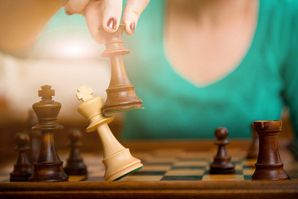 Woman playing chess stock photo