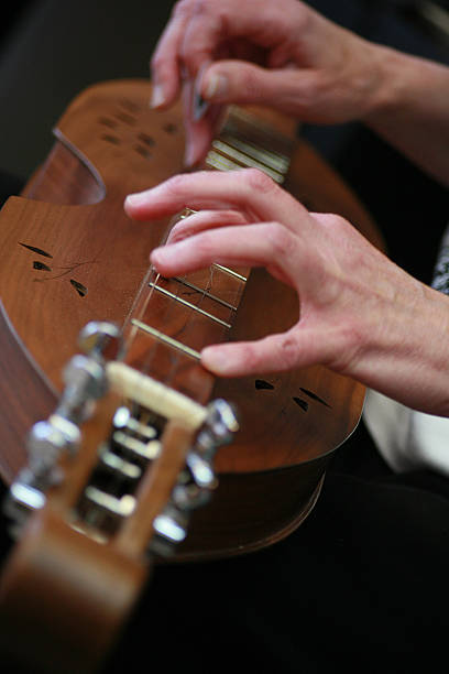 dulcimer2 closeup of woman's hands playing a dulcimer dulcimer stock pictures, royalty-free photos & images