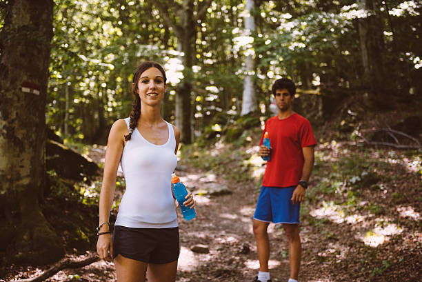 Two people pose on a trail stock photo