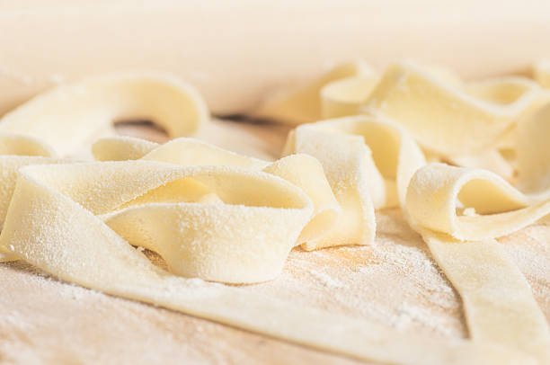 istock Cooking pasta fettuccine or tagliatelle dough 486938358
