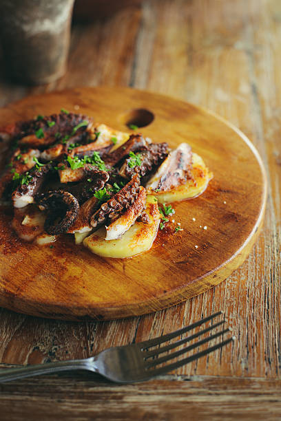 Traditional Spanish Galician dish: cooked octopus with boiled potatoes, sweet paprika and olive oil.