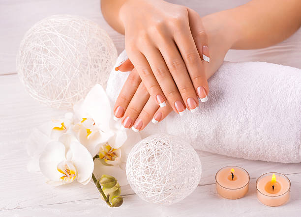 istock Beautiful hands with manicure and wnite orchid flower 486939033