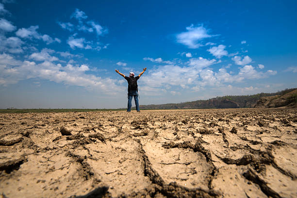 man standing on dry earth stock photo