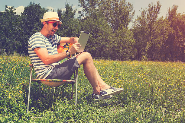 istock Young man in nature with tablet. 486939820