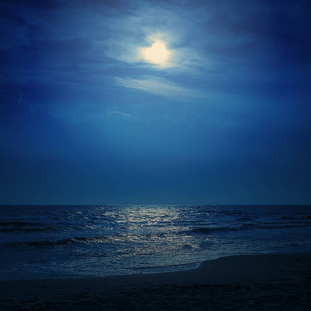 istock moon light in dark blue sky over sea 486940198