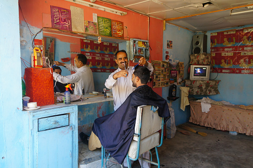 Kaghan Naran Valley,Pakistan - October 18,2014: Unknown Pakistani barber and his customer in  barber shop,Kaghan Naran Valley, Pakistan