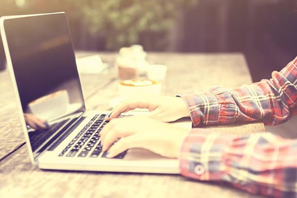 istock woman typing on a laptop at sunrise 486942630