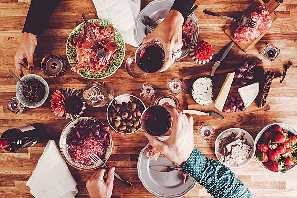 Dinner table overhead top view People having dinner overhead table top view cheese wine food appetizer stock pictures, royalty-free photos & images