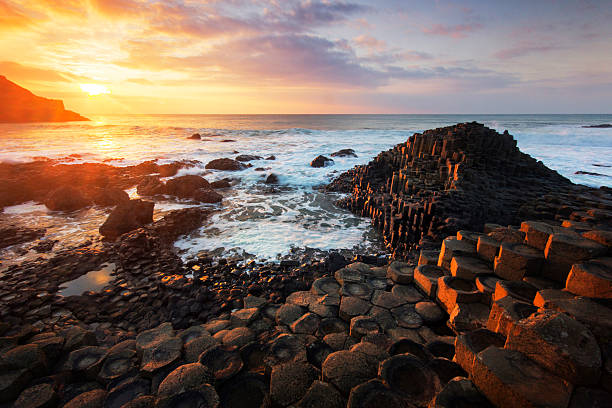 Beautiful sunset at the Giant's Causeway A beautiful sunset at the Giant's Causeway, UNESCO world Heritage site, Northern Ireland. giants causeway photos stock pictures, royalty-free photos & images