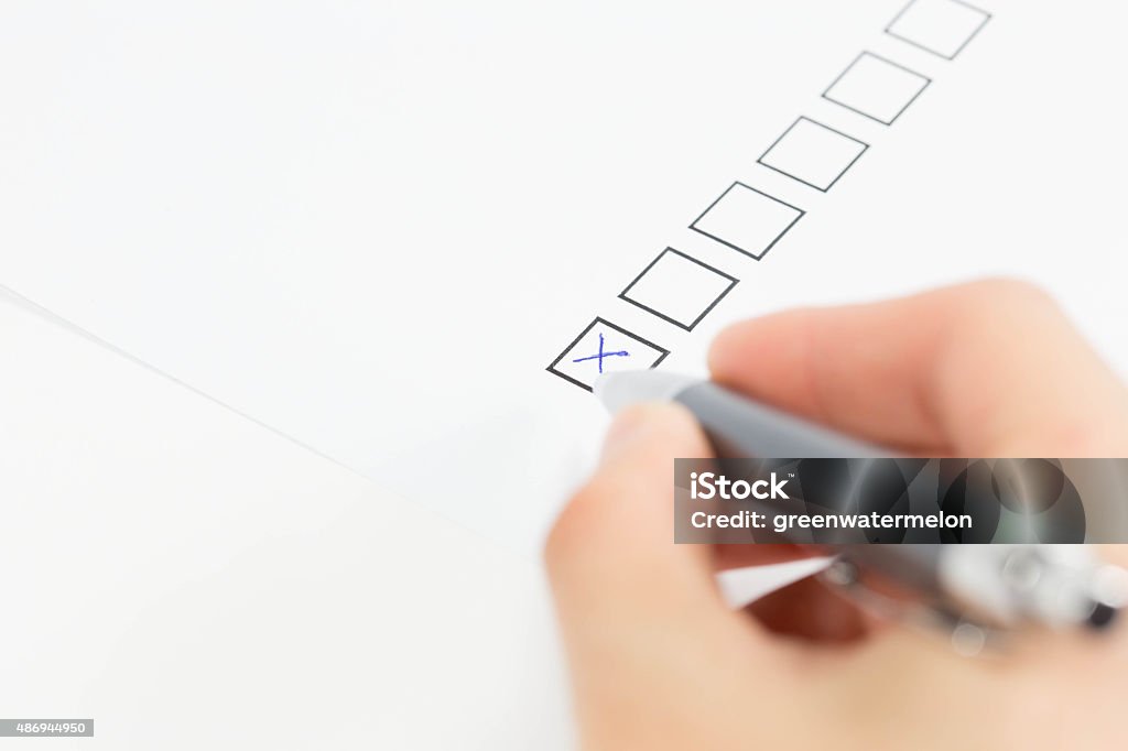 Checklist A paper and pen on a form with checklist checked 2015 Stock Photo