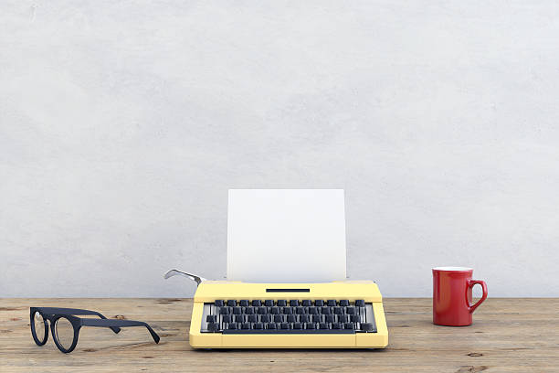 Roustic wall,with wooden desk in front of it, with a retro vintage working setup, typewriter, cup, glasses, frame. Copyspace