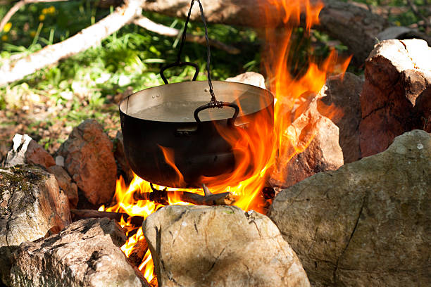 istock Pot water on the fire, tourists kettle on hot campfire. 486951788