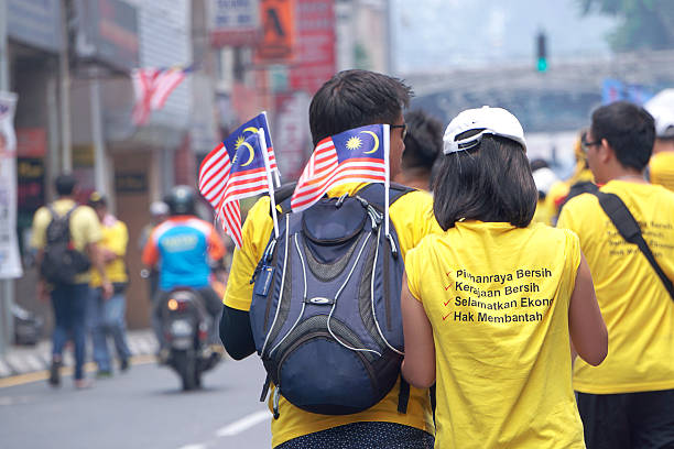 Bersih 4.0 Rally at Dataran Merdeka, Kuala Lumpur Malaysia Kuala Lumpur Malaysia - August 30, 2015. 2nd day of Bersih 4.0 Rally at Dataran Merdeka, Kuala Lumpur Malaysia. A couple walking togather for showing their solidarity during Bersih 4.0 Rally. koala walking stock pictures, royalty-free photos & images