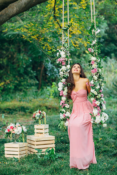 istock Beautiful young girl on a swing 486952936