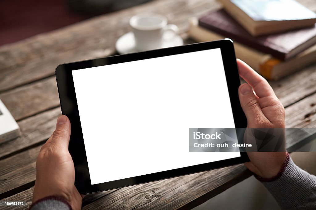 Man shows screen of tablet in his hands Man shows isolated screen of black digital tablet in his hands. 2015 Stock Photo