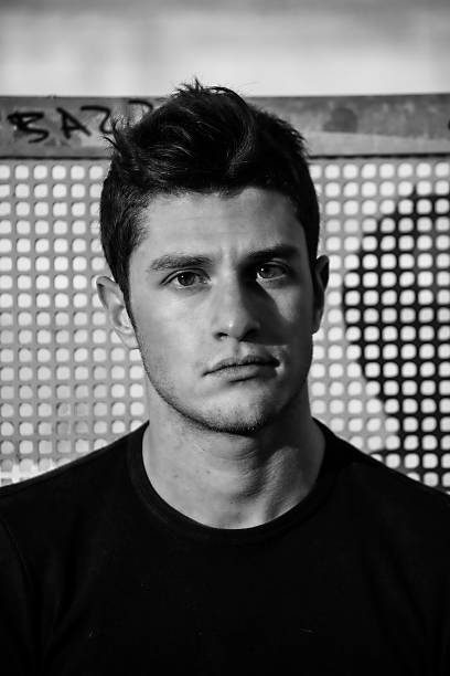 istock Headshot of attractive young man looking at camera, against grid 486955850