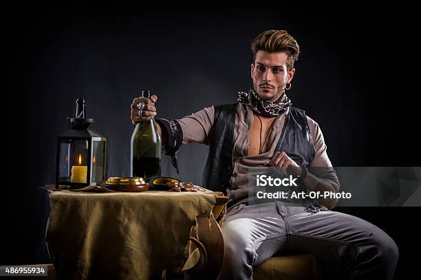 Good Looking Young Man In Pirate Fashion Outfit Sitting Next Stock Photo - Download Image Now