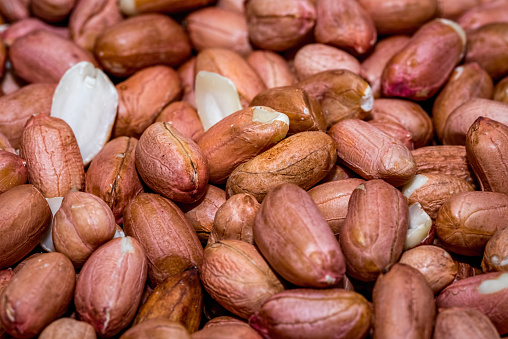 Macro view of some de-husked or shelled peanuts.