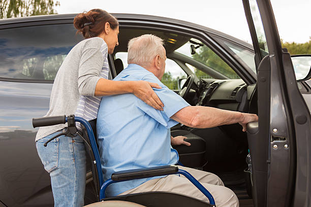 istock Caregiver helping senior into car 486959152