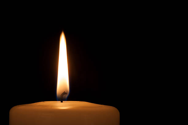 istock Burning candle in the dark with copy space 486959174