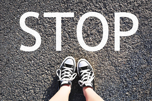 istock Standing in front of STOP sign 486960462