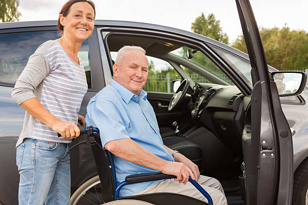 istock Caregiver helping senior into car 486960570