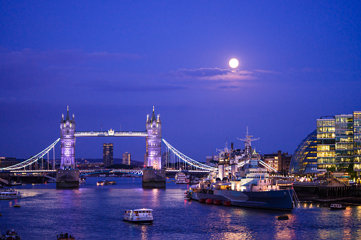 Looking down the Thames with a blue moon above.