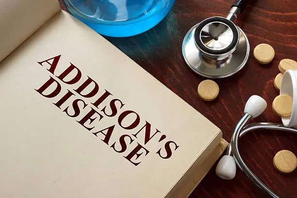 Photo of Addisons disease written on book with tablets.