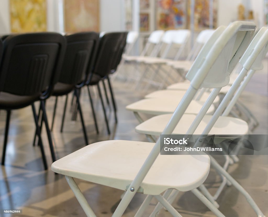 Black and White Conference Chairs Lines of black and white metal foldable chairs in a conference centre 2015 Stock Photo