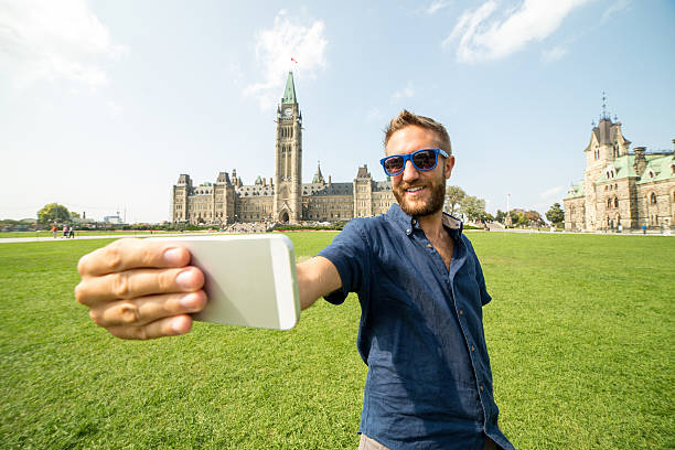 istock Young cheerful man in Ottawa-Canada taking a selfie portrait 486966678