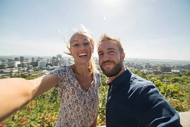 Photo of Young couple taking selfie in Montreal in Summer