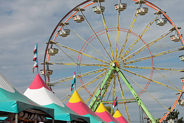 Fair Tents and Ferris Wheel Fair Tents and Ferris Wheel midway fair stock pictures, royalty-free photos & images