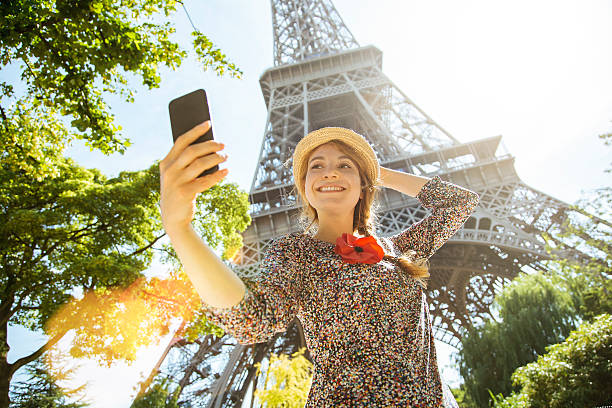 Paris, Woman photo messaging with eiffel tower in Background