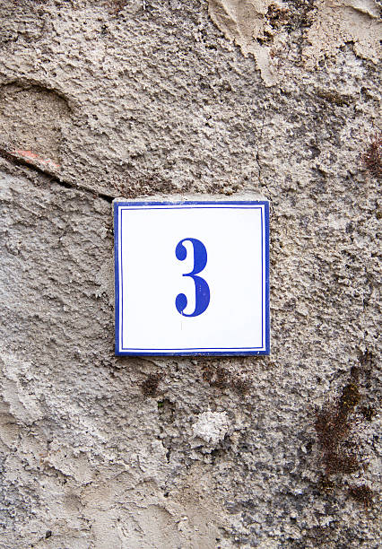 istock Number three on the grey stone wall 486973060