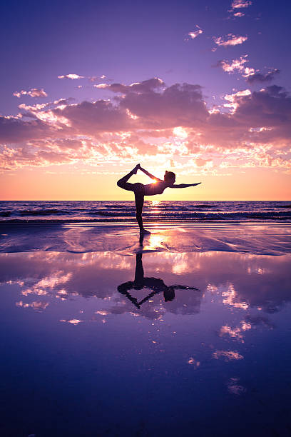 istock woman practicing yoga 486973342