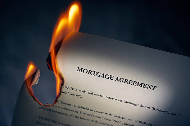 Mortgage Agreement Contract Burning On Fire stock photo