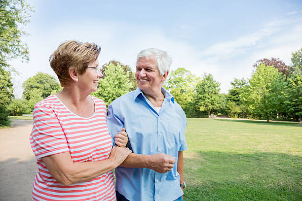 istock Happy senior couple walking outdoors in the park 486974376