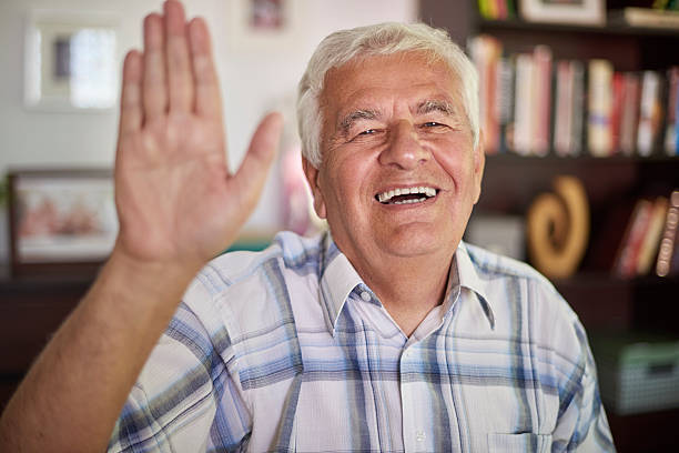 istock Senior man waving to the camera 486974400