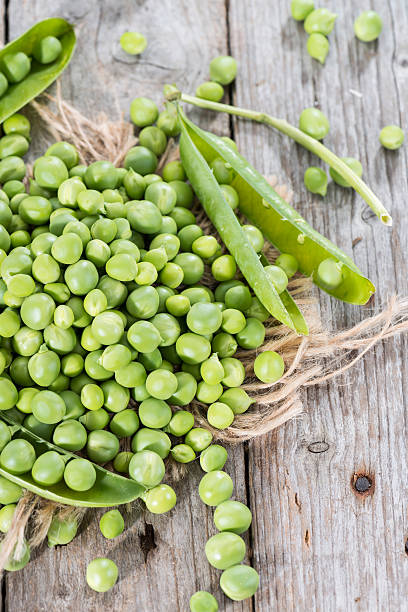 istock Fresh Peas on wooden background 486975609
