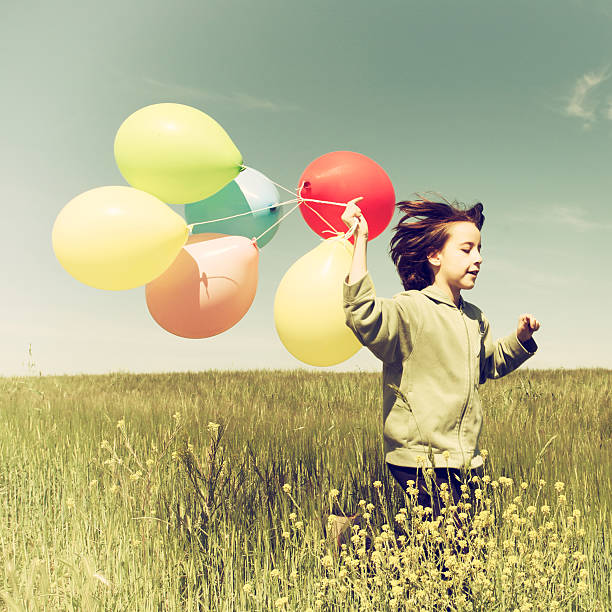 istock Little Girl With Balloons 486977337