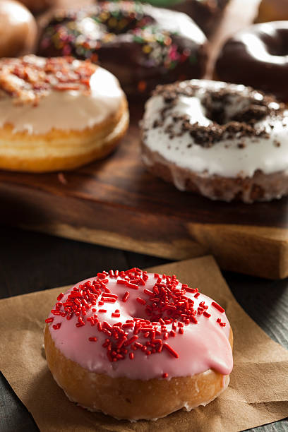 istock Assorted Homemade Gourmet Donuts on a Background 486977773
