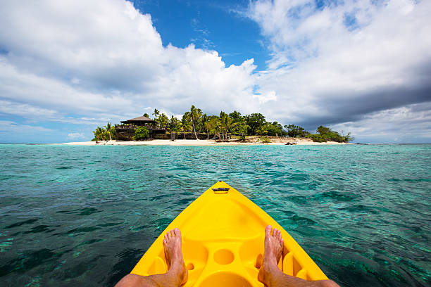 Kayaking by a tropical island in Fiji stock photo