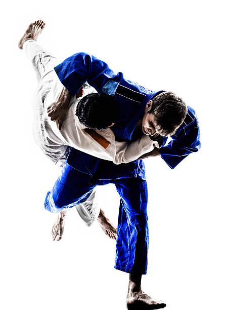 judokas fighters fighting men silhouettes two judokas fighters fighting men in silhouettes on white background judo stock pictures, royalty-free photos & images