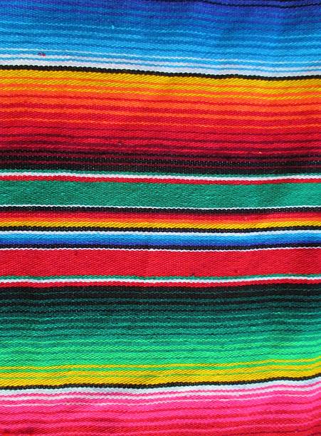mexican fiesta serape poncho cinco de mayo background Mexican traditional handwoven rug poncho fiesta with stripes and bright colors background regional2014, dia de los muertos, cinco de mayo, day of the dead, Dia De Muertos tapestry photos stock pictures, royalty-free photos & images