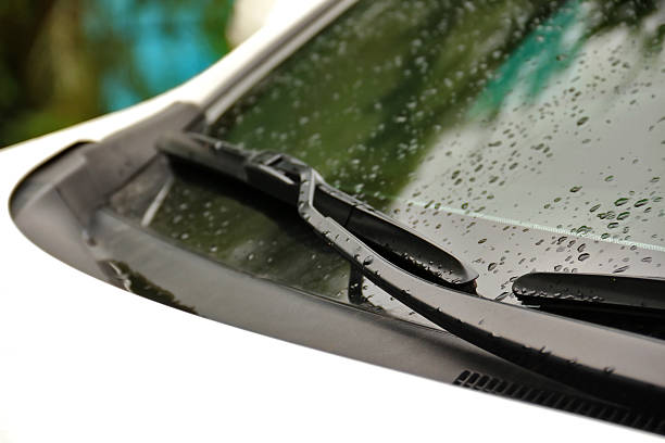 istock Wipers on windshield of car close up on rainy day 486978670