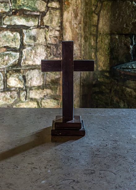 istock Wooden cross on a stone altar 486978913